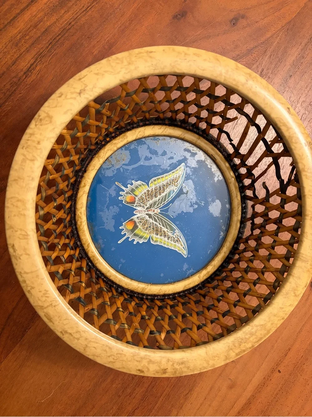 Vintage woven basket with central blue butterfly medallion